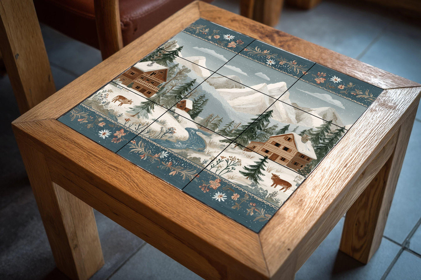 Tile mural of a snowy alpine village: winter cabin scene with mountains, fir trees, and cows. Ceramic wall art for rustic homes and cozy interiors.