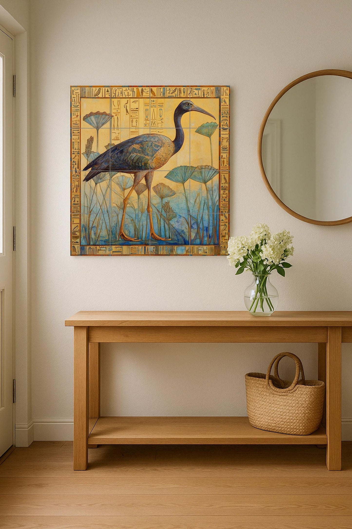 Ceramic mural with ibis among papyrus: Egyptian-inspired tile artwork with hieroglyphic border in muted yellow and blue.