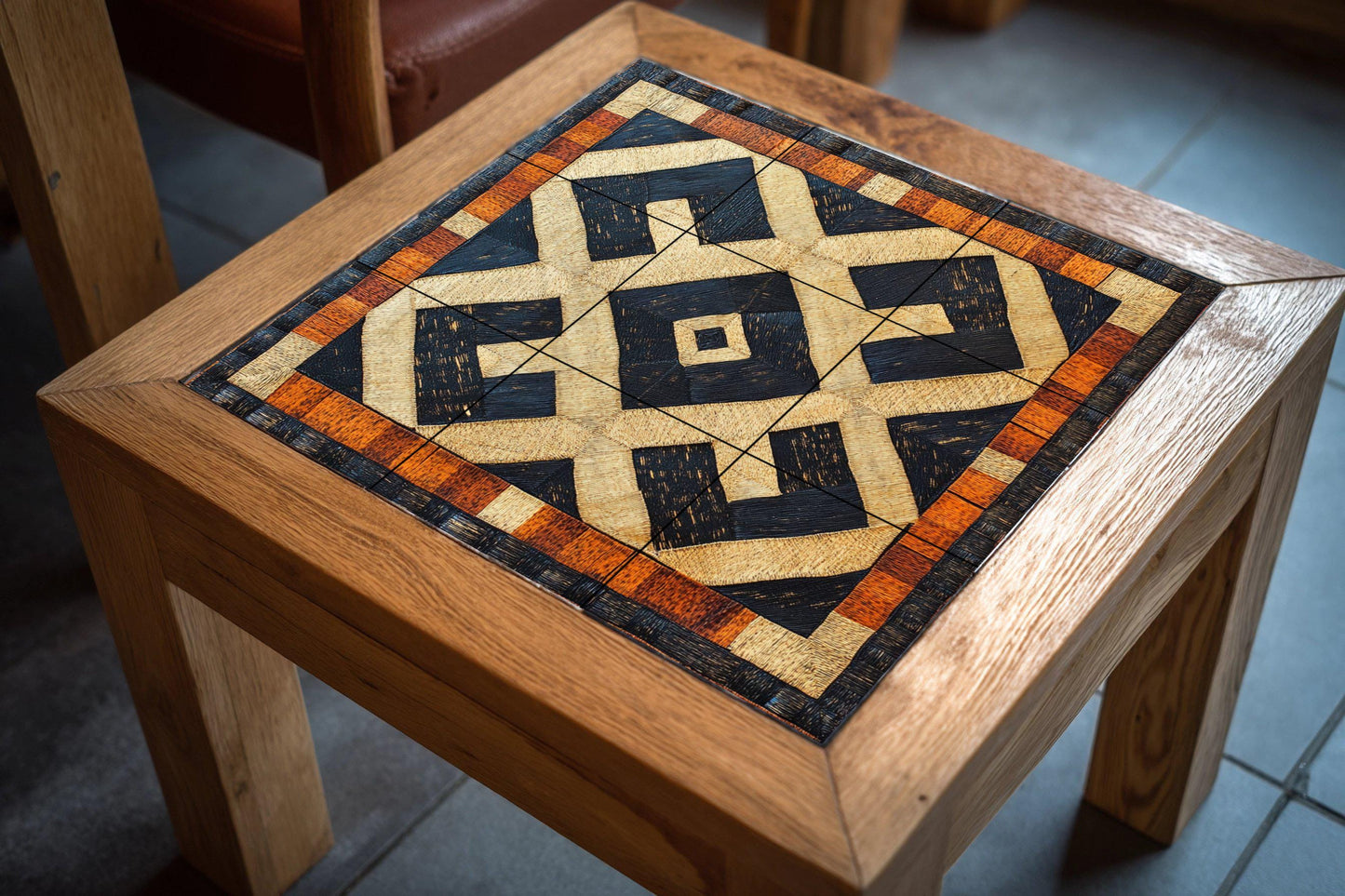 Congolese Kuba ceramic mural: Tribal-inspired tile artwork in raffia with striking geometric patterns and African heritage mural art.