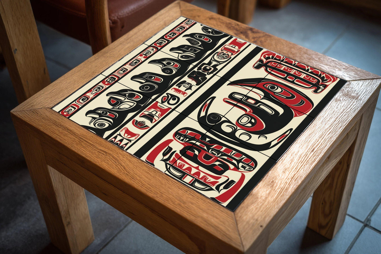 Inuit-inspired ceramic mural: mosaic artwork featuring northern animal motifs, bold black and red patterns, and tribal details on the edges.