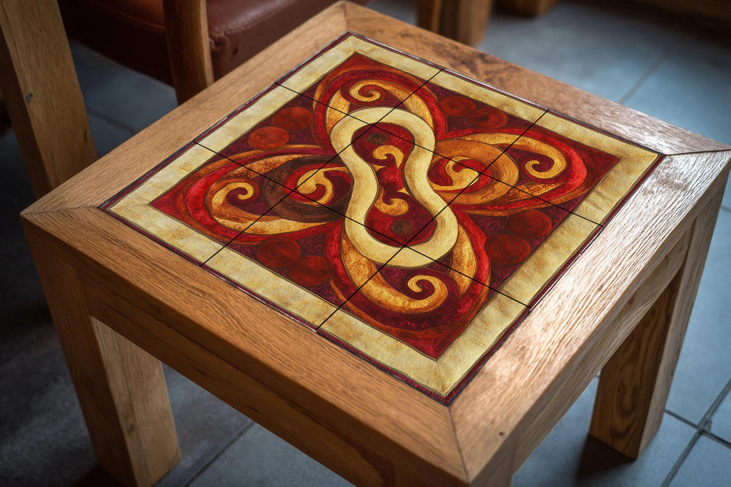Ceramic mural with Mongolian knot: felt-inspired tile art with red and gold swirls, yurt decorative motif, striking abstract wall detail.