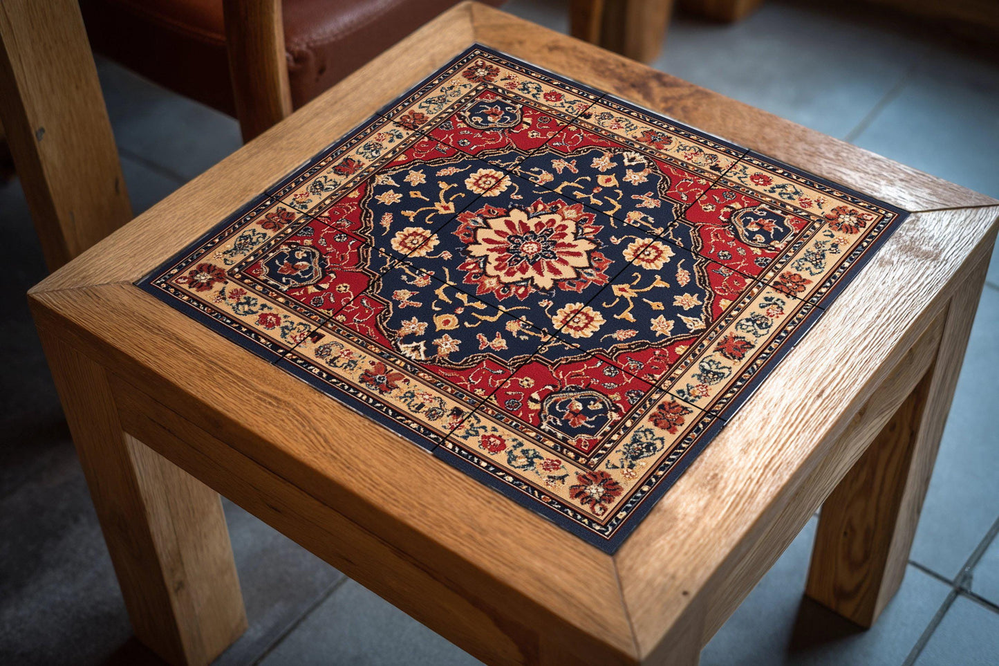 Persian ceramic mural from Mashhad with ornamental medallion and deep red and navy blue tiles, wall art inspired by traditional floral carpets.
