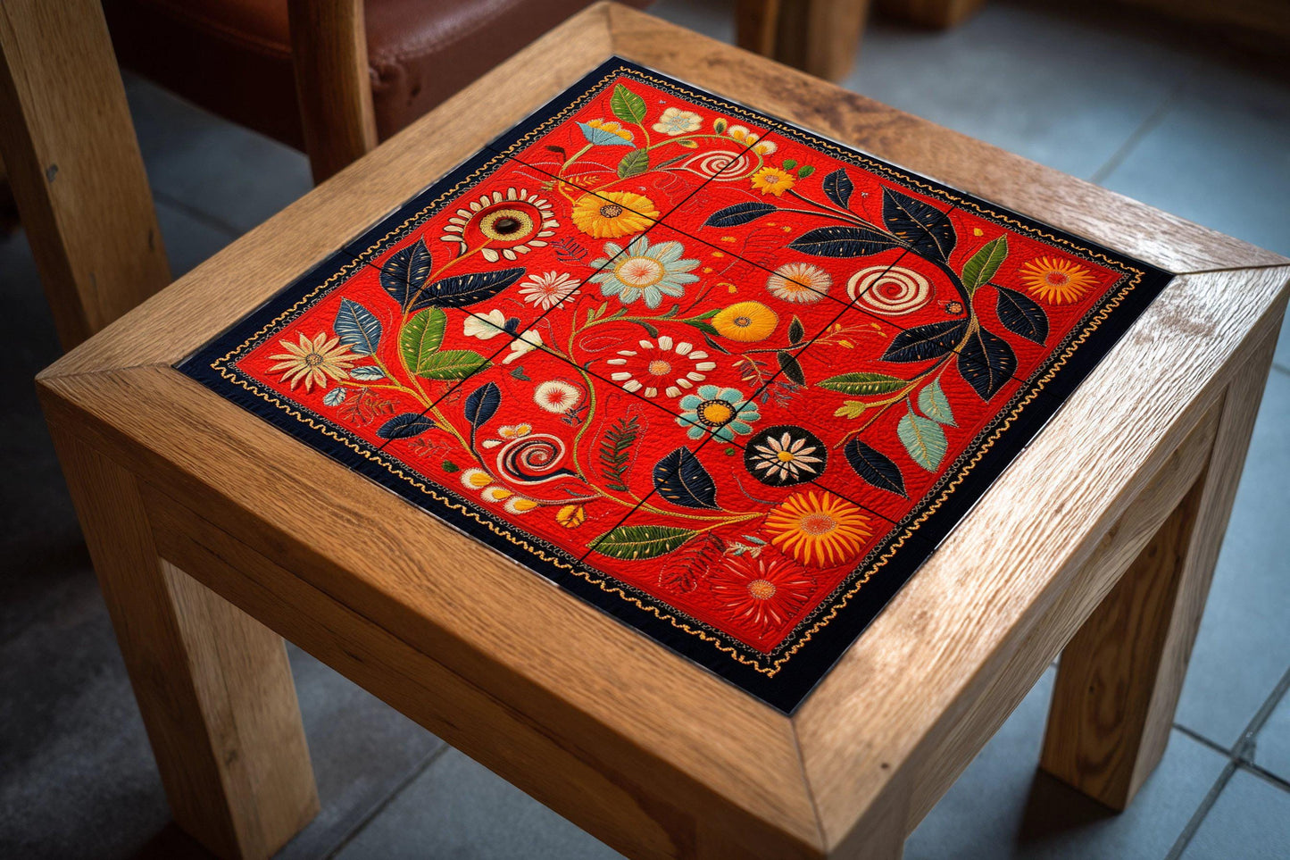 Deep red ceramic mural with botanical swirls, spiraling flowers, golden flowers and a decorative artistic touch.