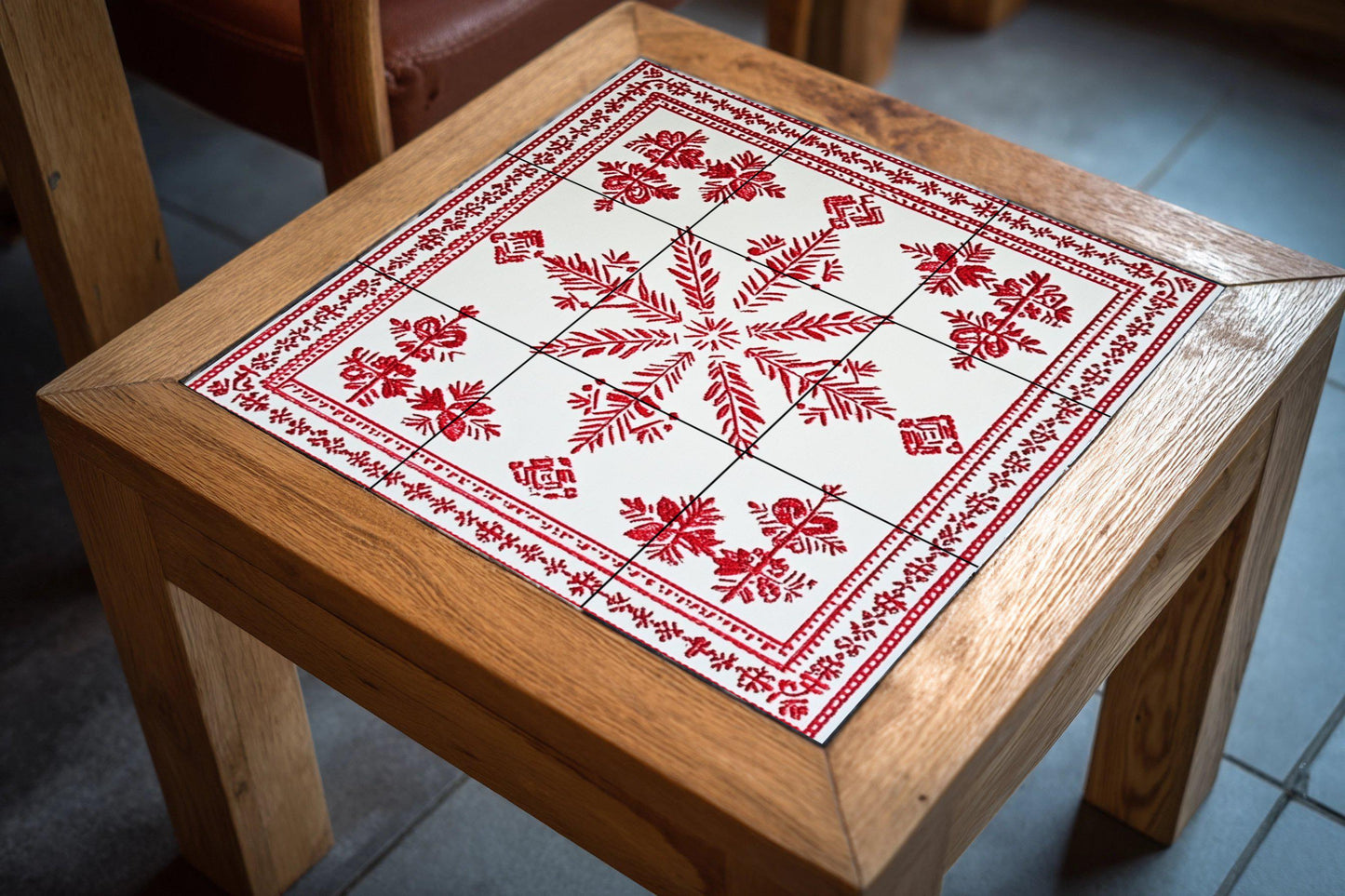 Ceramic mural: design inspired by the Belarusian Vyshyvanka, with red embroidered motifs and a popular geometric pattern on white tiles.