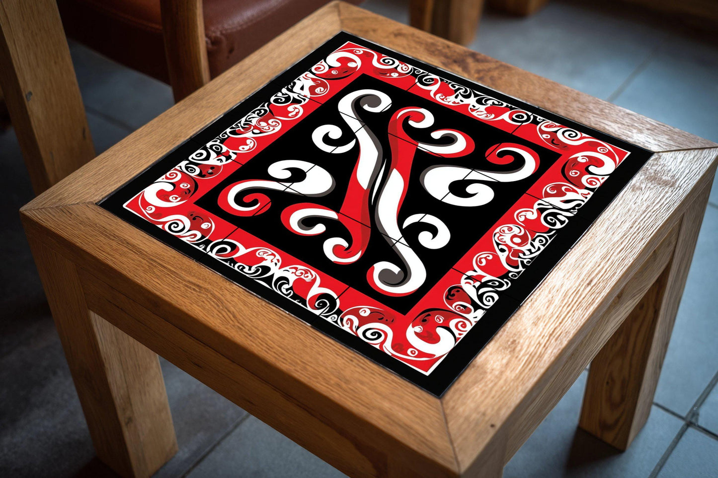 Polynesian Tribal Ceramic Mural: Maori-inspired tile artwork with abstract design in red, black and white, cultural decorative wall art.