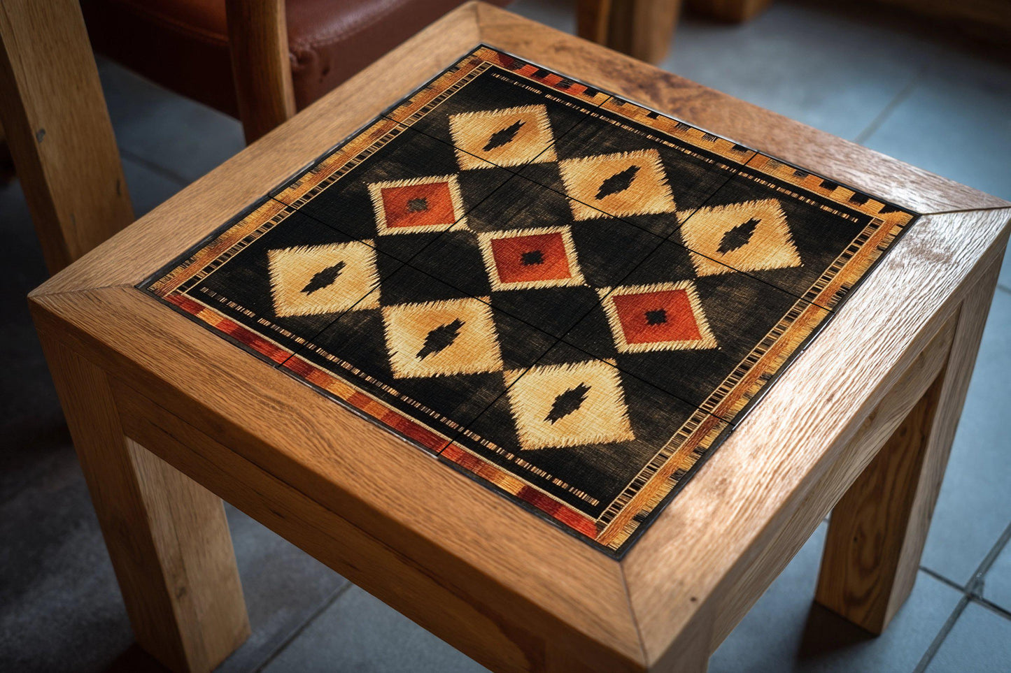 Modern Southwest ceramic mural: geometric diamond pattern in earth tones of black, gold and terracotta.