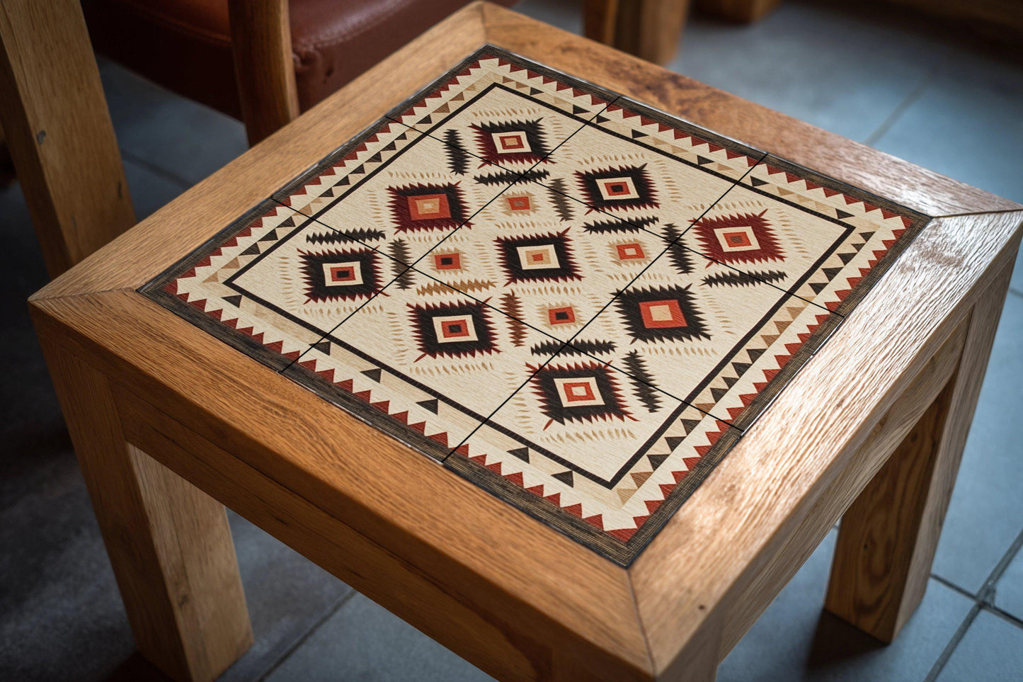 Navajo textile ceramic mural: Southwest rhombuses and earth tones in zigzag with hand-woven border.