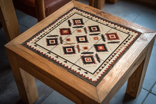 Navajo textile ceramic mural: Southwest rhombuses and earth tones in zigzag with hand-woven border.