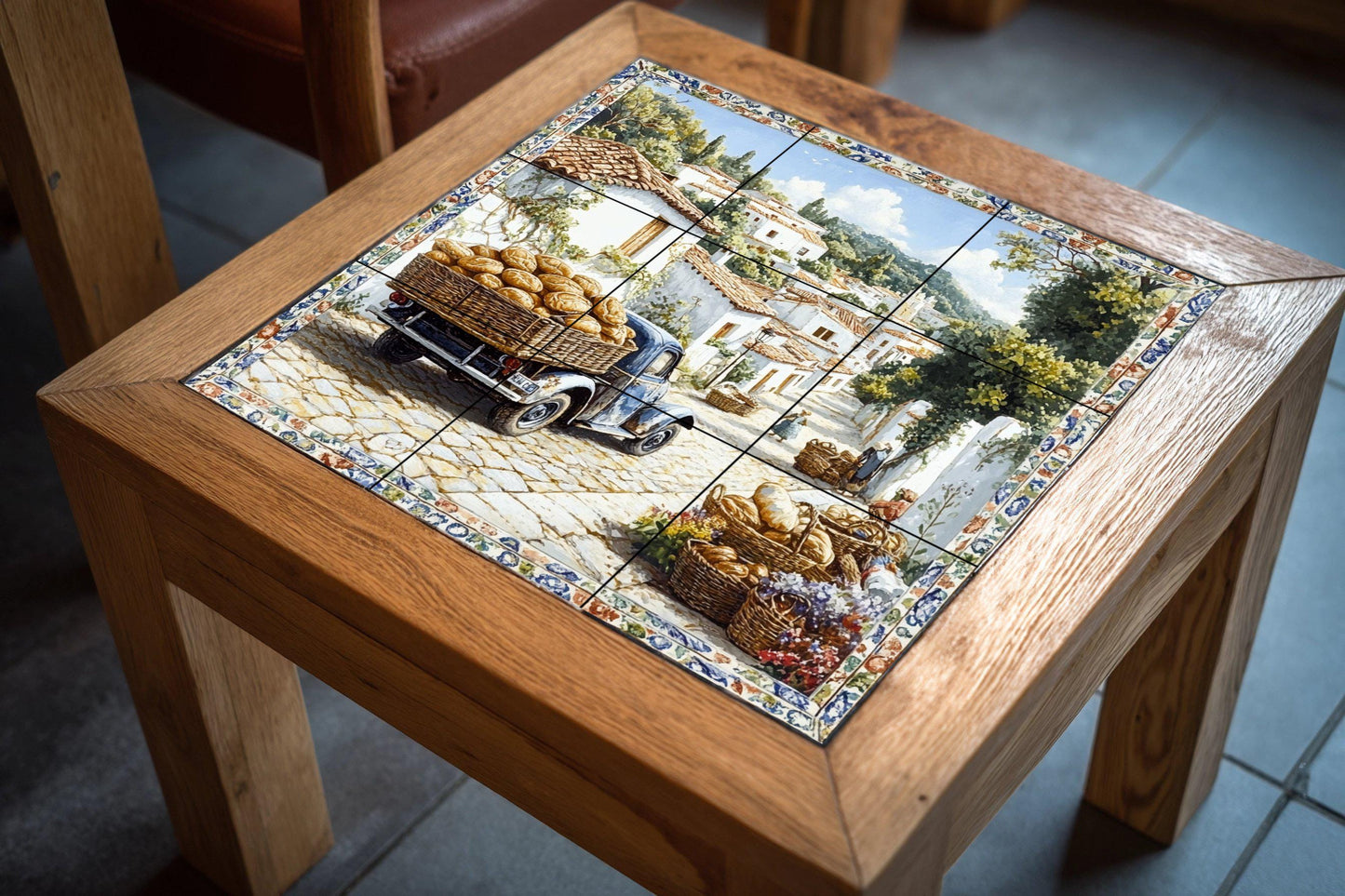 Ceramic mural of a village in southern Italy: a rustic bread cart on a sunny street with whitewashed houses and cobbled paths.