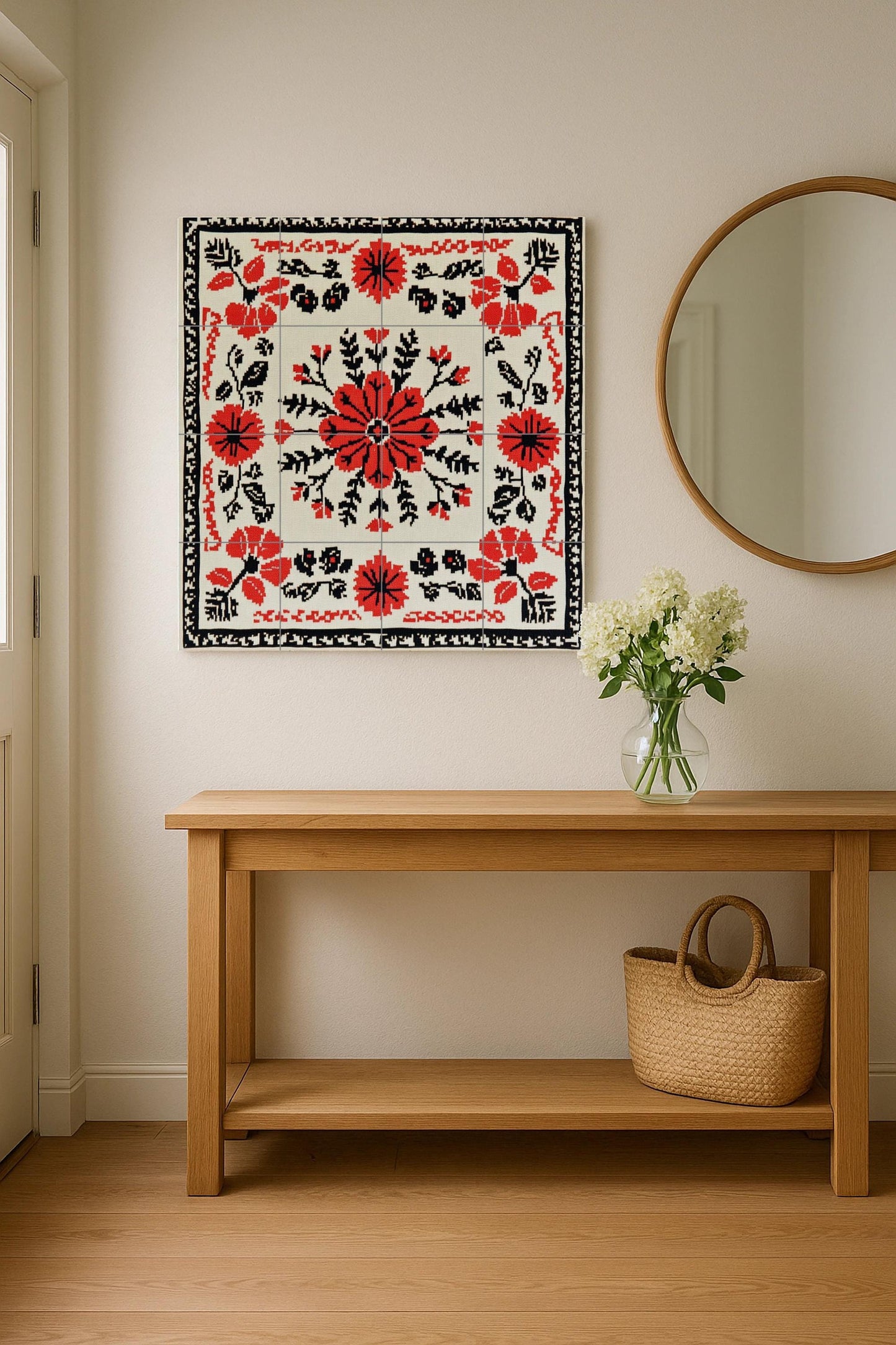 Romanian embroidered mural: floral ceramic mural art in red and black cross stitch with folk vine stitch border, Balkan textile design.