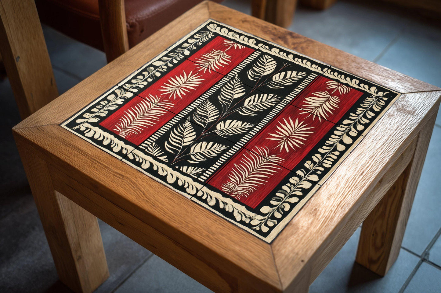 Garnet ceramic textile mural from Suriname: linear motifs in red, black and white with jungle leaves, Afro-Caribbean heritage mural art panel.