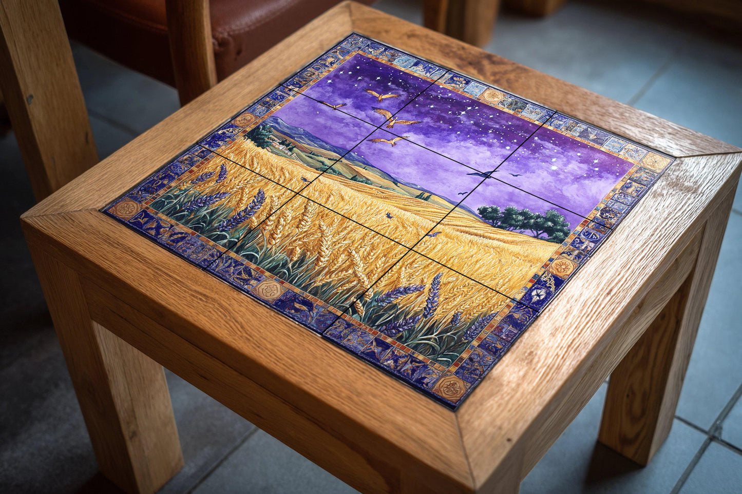 Ceramic mural of a wheat field on a starry night: mosaic of the golden harvest with birds in flight, purple sky, ornamental border and countryside landscape.