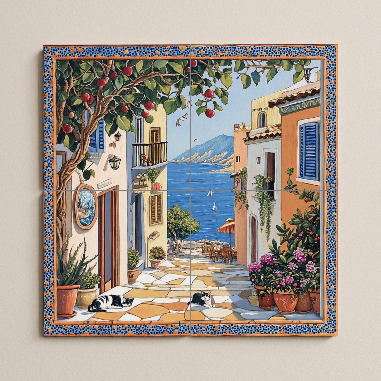Ceramic tile mural with street scene of a coastal town, fruit tree, flower pots, houses by the sea and black and white cats resting on the pavement.