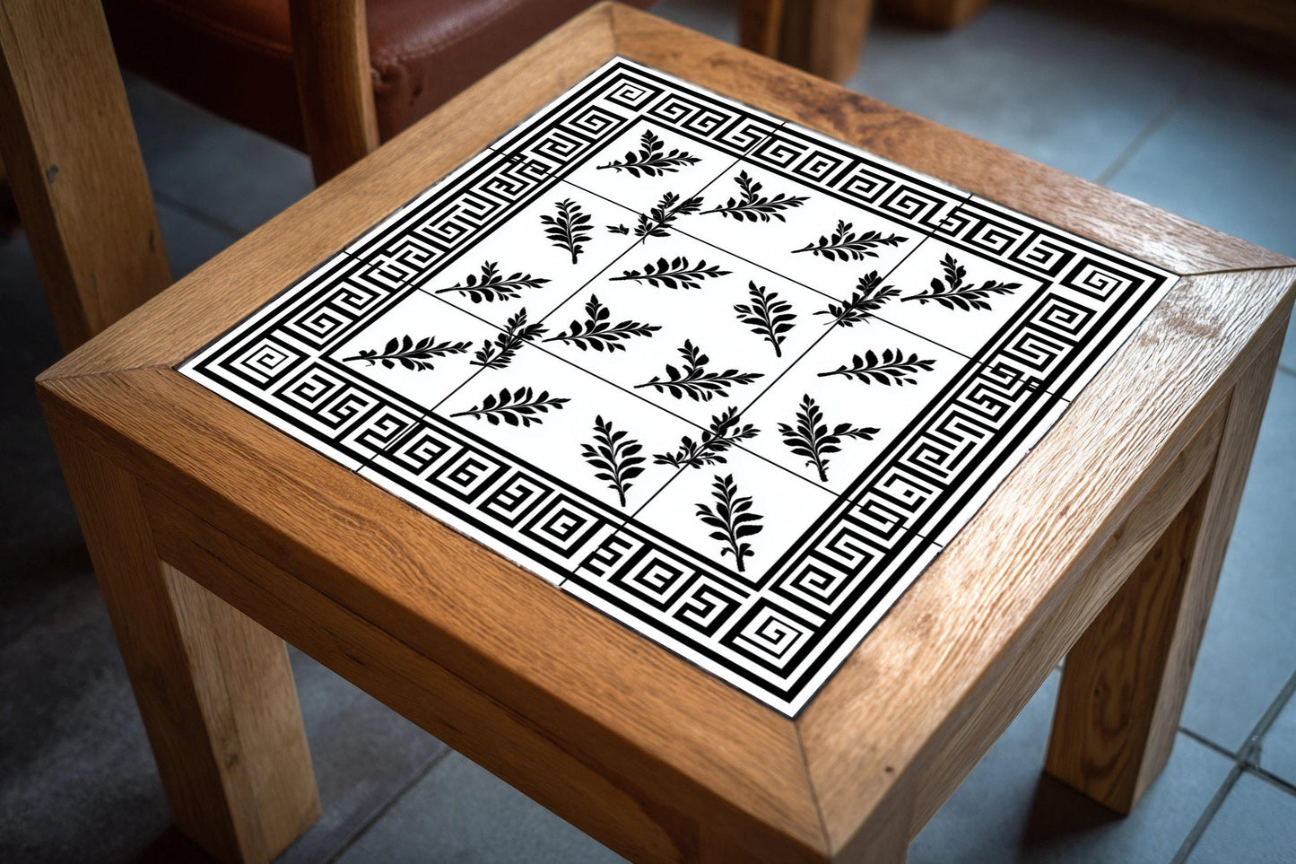 Ceramic tile mural with Greek key, black and white laurel leaf decorative panel, classic Hellenic design for decoration.